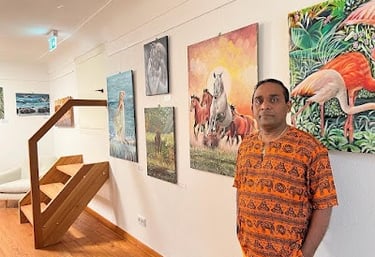 Artists Perl Perera with some of his work