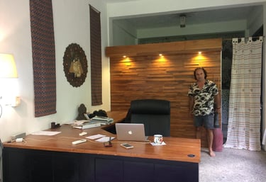 a woman standing in front of of a blines hand made desk with a laptop