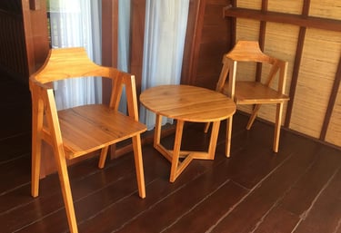 two chairs with wooden chairs and a table