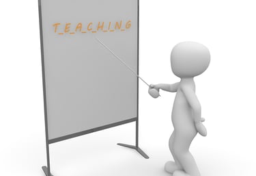 Solhouette pointing to a white board with a pointer stick with Teaching written on the board