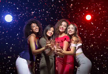 Group of women celebrating at a VIP nightclub party in Las Vegas, holding champagne glasses and enjoying the night.