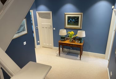 Blue-painted hallway with white doors and trim in Dulwich, professionally finished by Pure Perfectio