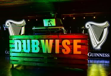 Dubwise logo lit with red yellow and green lights with the Guinness logo placed behind on each side