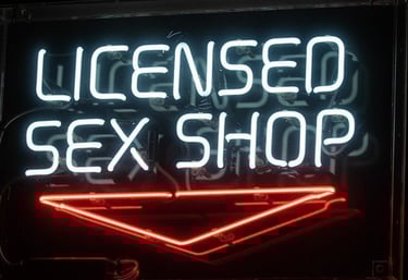 a neon sign that reads licensed sex shop
