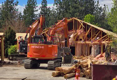 Two Excavators demolishing a structure