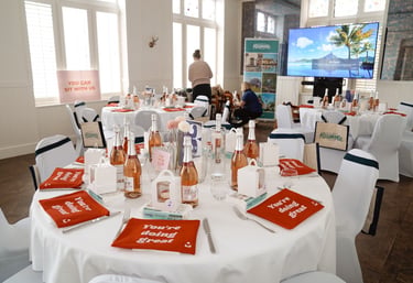 event set up with champagne on the table and gift bags