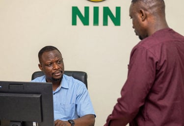 A professional consultant assisting a client with NIN registration paperwork.