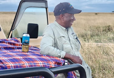 Mr Sammy in safari gear during a sundowner with clients at Maasai Mara