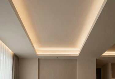 An elegant modern ceiling with multi-level drywall construction and integrated warm lighting strips in a refined Southern European dining room.