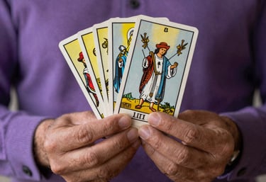 Focus on two hands holding a tarot deck with mystical symbols, soft thistle-colored lighting, South American professional setting.