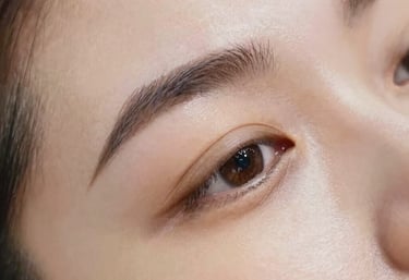 Close-up of a woman receiving a gentle facial massage in a serene, softly lit environment.
