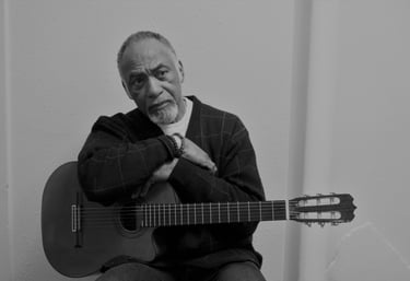 Late actor William S Taylor holding a guitar while filming a scene in Coco Blue