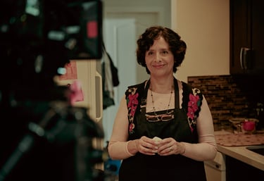 Actress Magda Ochoa smiling to the camera in a scene of Lupe Q and the Galactic Corn Cake