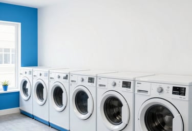 Bright, clean self-service laundry area with washing machines and folding tables.