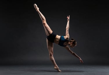 A professional contemporary dancer in a high-speed pirouette, captured with precision in a dark studio. Electric cyan light highlights the biomechanical alignment of the body. North American / International.