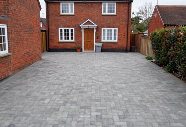 A friendly contractor discussing driveway plans with a homeowner on site.