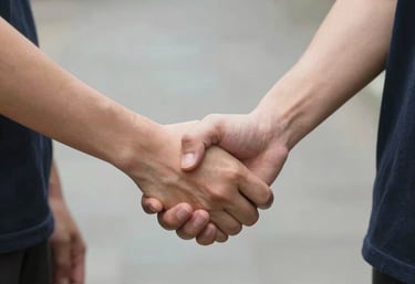 A friendly team of insurance experts discussing plans around a table in a bright office.