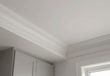 A friendly handyman from Carolina Home Pros installing elegant crown molding in a cozy living room.