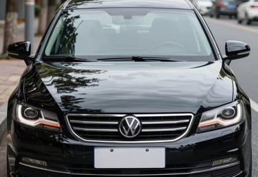 A skilled mechanic carefully inspecting a used car engine in a bright workshop.