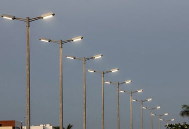 A row of modern street light poles recently installed in a Brazilian urban development, dusk lighting, emphasizing infrastructure success.