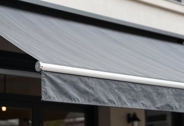 A stylish outdoor commercial terrace with a professional retractable awning in slate grey textile.