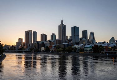 The Melbourne skyline reflecting on the Yarra River at sunset, captured in a clean, professional style with soft golden and navy tones.