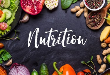 Black table featuring the word “Nutrition” in large letters, surrounded by a variety of foods for display.