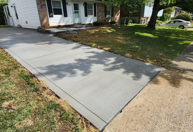 a freshly poured driveway with sidewalk