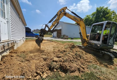 a construction worker is using a machine to remove dirt from the ground