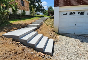 a set of stairs leading up to walkway around a garage