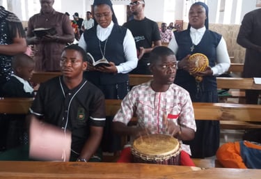 Catholic nuns and parishioners singing and playing traditional drums during a church service.