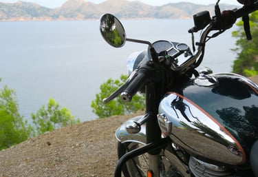 A Royal Enfield Classic overlooking Alcudia Bay in Mallorca