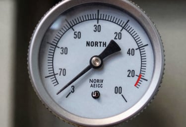 A close-up of a digital HVAC pressure gauge set showing precise technical readings during a system performance test, North American / US.