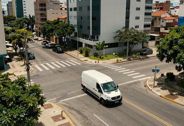An overhead shot of a delivery van moving through a clean, organized urban intersection in a modern Brazilian neighborhood during the day.