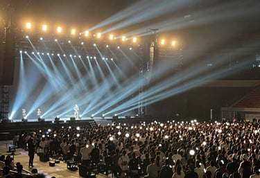A vibrant conference room set up with elegant lighting and attentive guests.