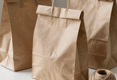 Sustainable and eco-friendly packaging for fruit delivery, featuring brown recycled paper bags and natural jute twine on a clean white surface.