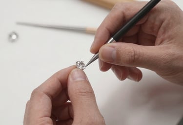 Close-up of a master jeweller delicately crafting a gold necklace with fine tools in a warm, inviting workshop.