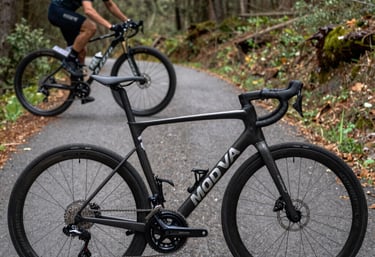 A dynamic split composite image showing a professional carbon road bike on asphalt and a mountain bike deep in forest terrain, highlighting the key cycling disciplines in Moldova.