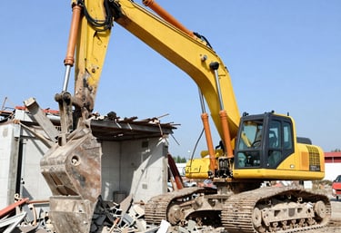 Close-up of heavy machinery smoothing earth for a building foundation.
