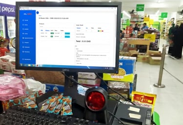 Point of sale system showing inventory software on a monitor at a retail grocery store checkout counter.