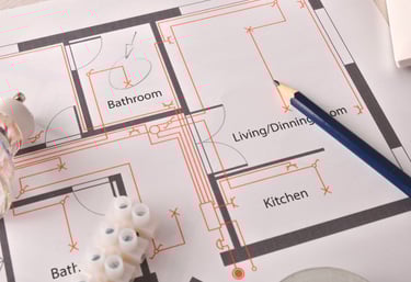 Residential electrical blueprint with pencil and wiring connectors for home renovation planning.