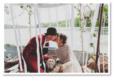 Husband and wife kissing on a boat.