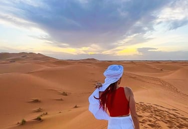 a woman in a white dress and a red scarf