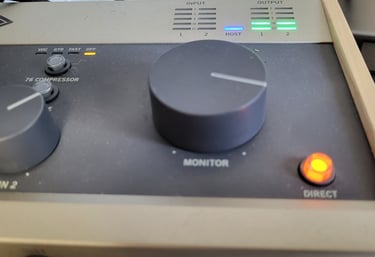Ein Mischpult für die Audioaufnahme, an dem Lämpchen leuchten und ein Regler aufgedreht ist