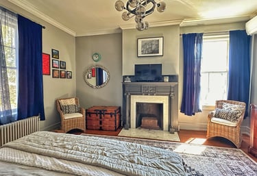 bedroom with fireplace and chandelier 2123 rivermont apartments