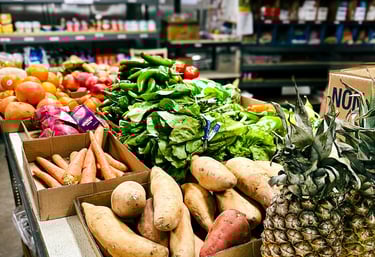Pantry interior with table of fresh produce and shelves with canned and boxed food