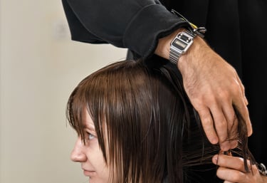 A Man cutting young woman's  at Just Teasin salon