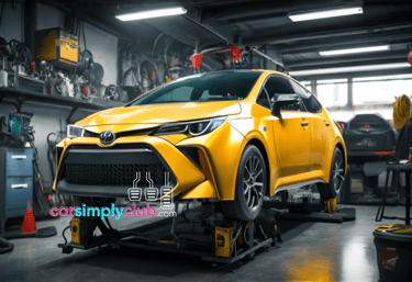 a yellow toyota car is shown on a lift in a garage in this image