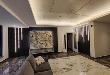 a living room with a couch and a large painting