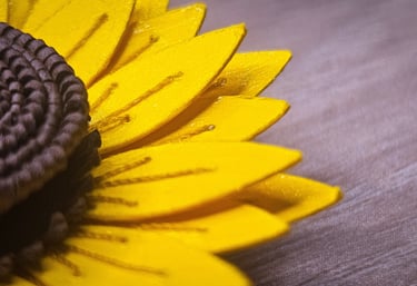 a sunflower with a yellow flower on a wooden table